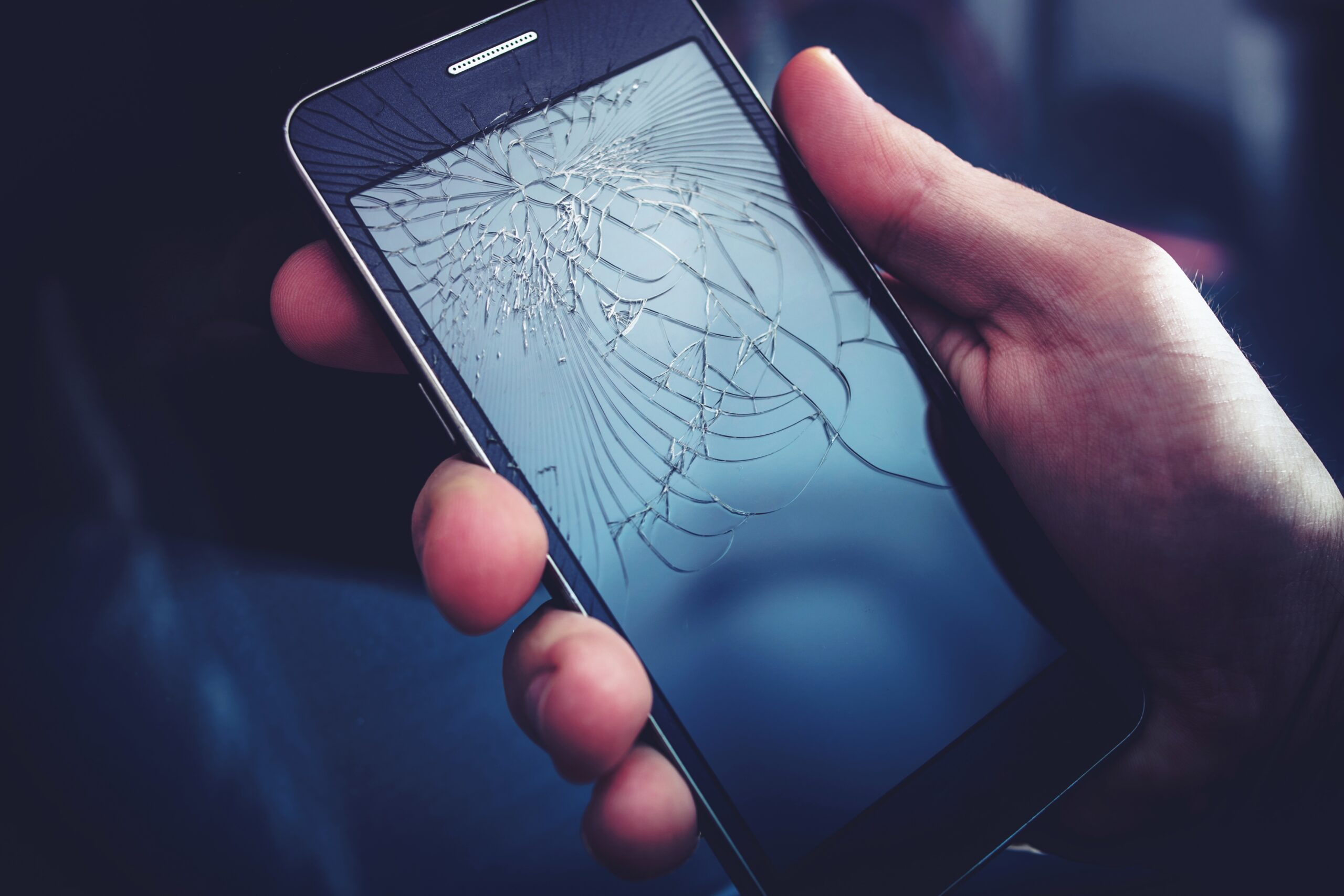 Broken Smartphone Display. Crashed Cellphone in Hand.
